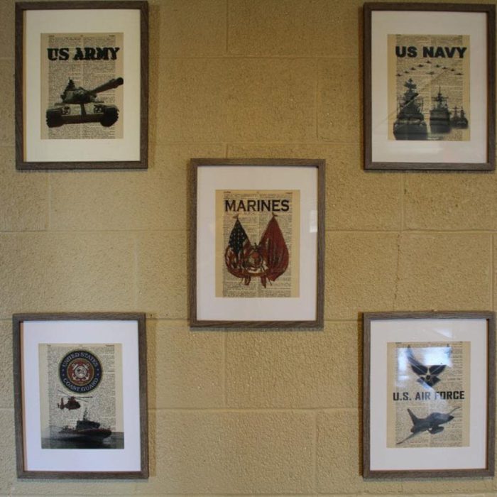 Military-style pictures hanging on wall at Fiddler's Green-Senior Living in Bad Axe, Michigan
