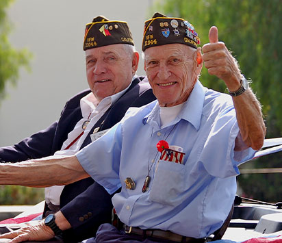 Veterans smiling, giving thumbs up